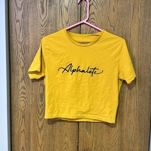 Alphalete Mustard Yellow Script Logo Crop Tee